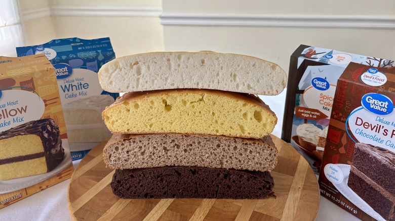 Stack of four Great Value cakes surrounded by boxes of cake mix