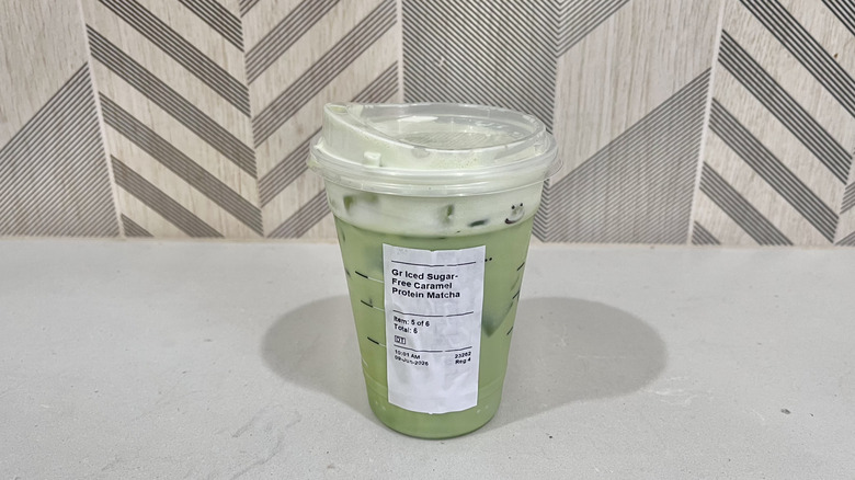 Sugar-Free Caramel Protein Matcha in a plastic cup