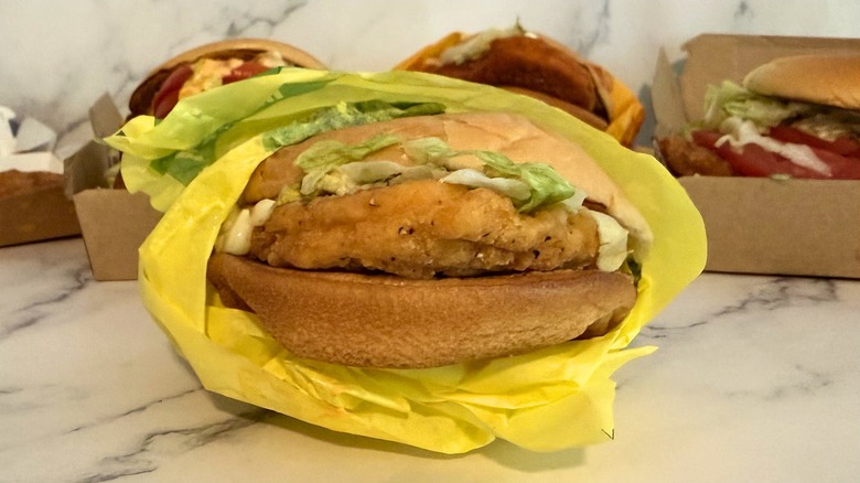 McDonald's McChicken, partially wrapped on marble surface