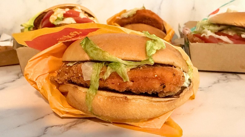Partially wrapped hot and spicy mcchicken on marble surface