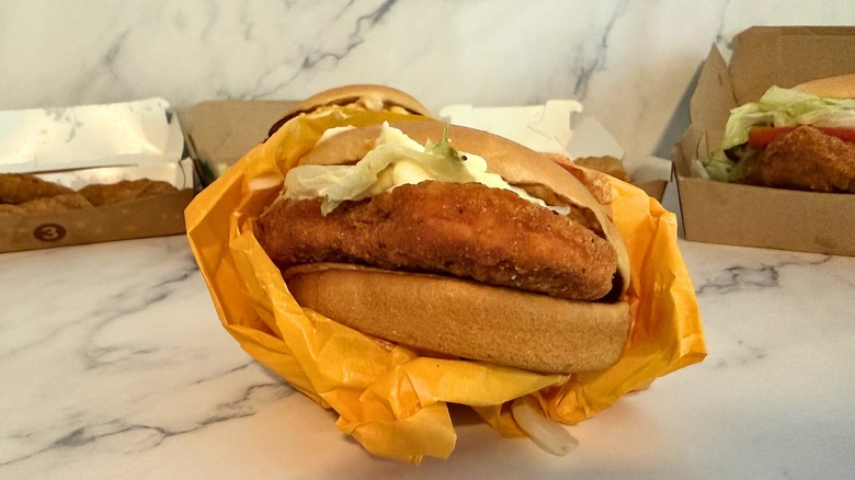 McDonald's Spicy McChicken partially in wrapper on marble surface