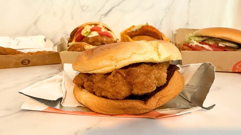 Half-wrapped McCrispy sandwich on marble surface