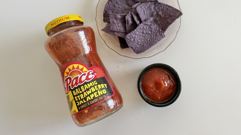 Balsamic Strawberry Jalapeño salsa jar next to chips