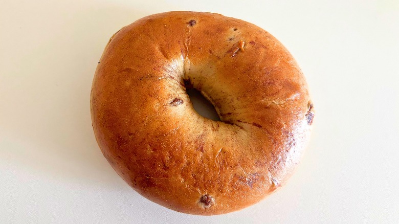 Top-down shot of Panera Cinnamon Raisin bagel on white surface