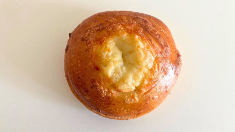 Top-down shot of Panera Asiago bagel on white surface
