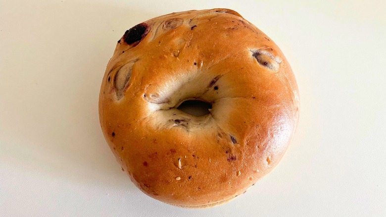 Top-down shot of Panera Blueberry bagel on white surface