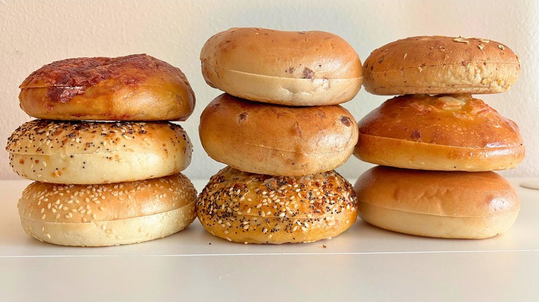 Three stacks of three bagels on white table