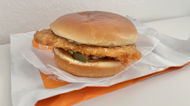 Fish sandwich on a wrapper from Popeyes
