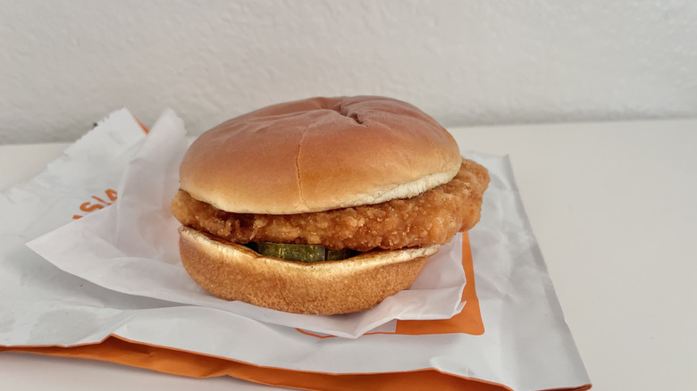 Spicy flounder sandwich on a wrapper from Popeyes