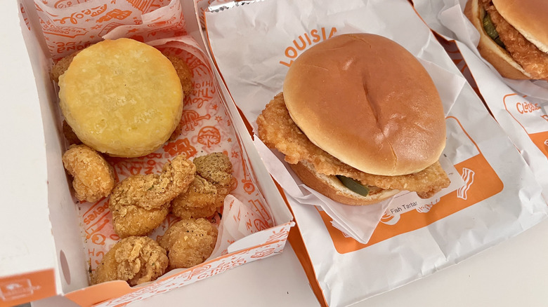 Shrimp and fish sandwich on table from Popeyes