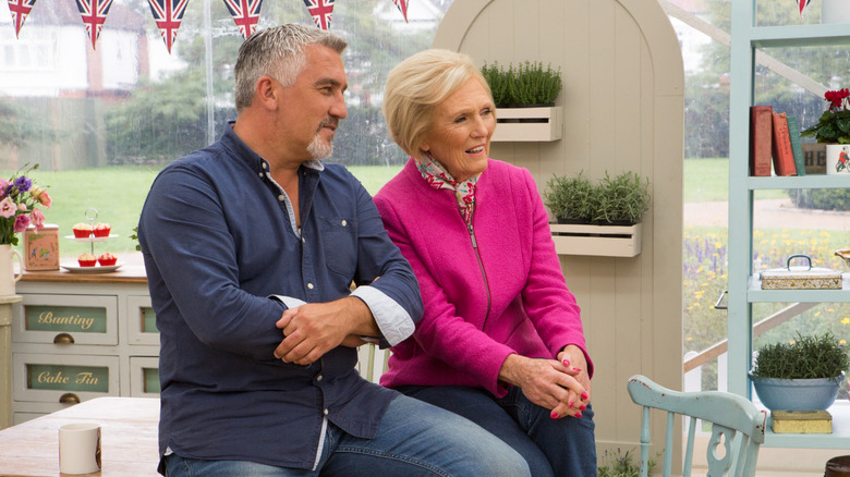 Paul Hollywood and Mary Berry during filming of Great British bake off sitting in a tent