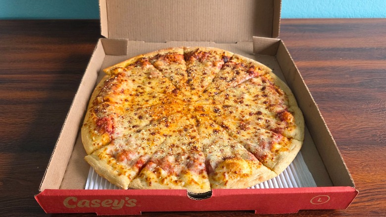 Casey's four cheese pizza in a pizza box