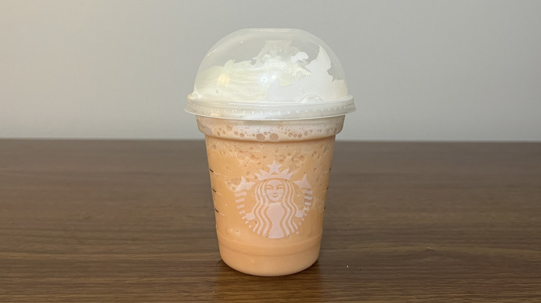 Starbucks Orange Cream Creme Frappuccino in to-go cup.