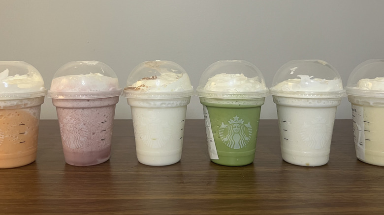 8 colorful Starbucks Creme Frappuccinos in a line.