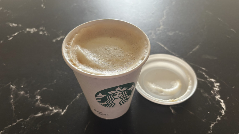 Starbucks vanilla latte with lid removed from cup