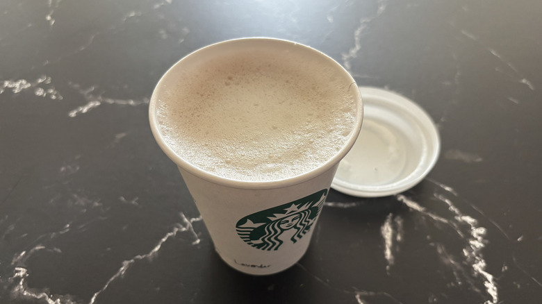 Starbucks lavender latte with lid removed from cup