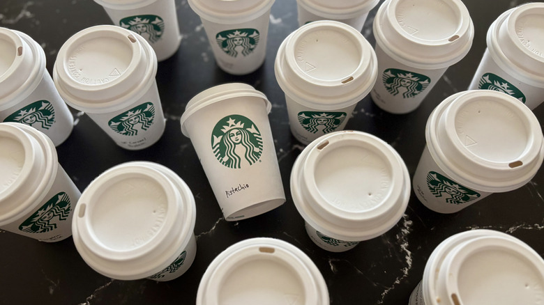 Various Starbucks hot latte cups on countertop