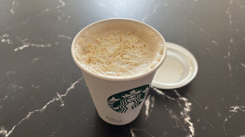 Starbucks pecan crunch latte with lid removed from cup