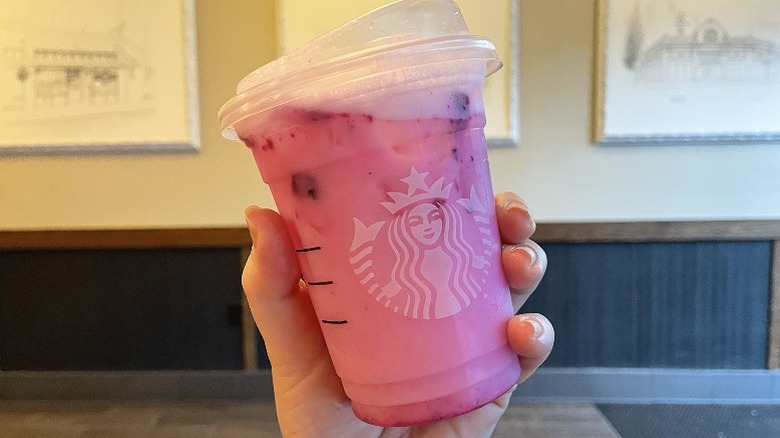 Hand holding the Dragon Drink Refresher in a cafe