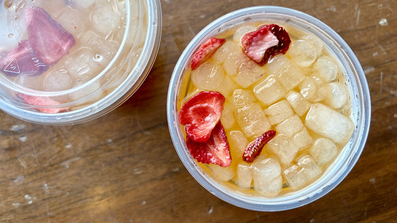 A Starbucks Mango Strawberry Refresher with other drinks