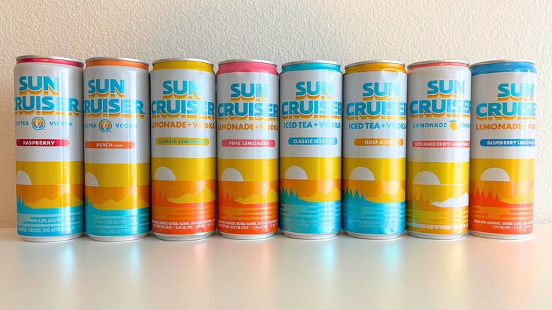 Eight Sun Cruiser canned cocktails lined up on table