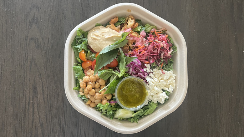 Sweetgreen Hummus Crunch salad in to-go container with a dressing packed inside