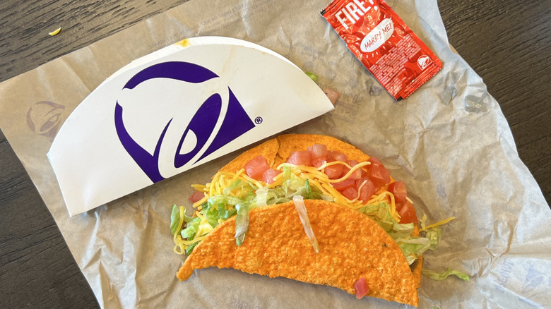 Taco Bell Nacho Cheese Doritos Locos Tacos Supreme with sauce packet.