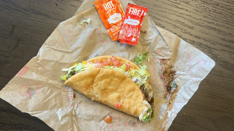 Taco Bell Black Bean Chalupa Supreme with sauce packets.