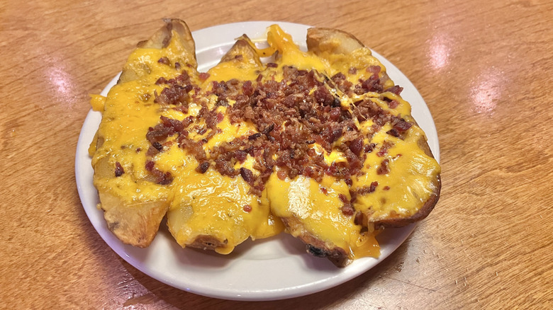 Four pieces of tater skins with cheese and bacon