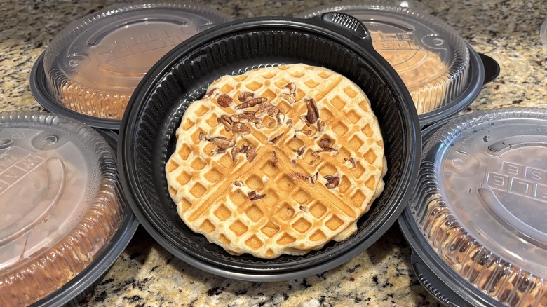 Waffle House pecan waffle in branded to-go containers on marble counter