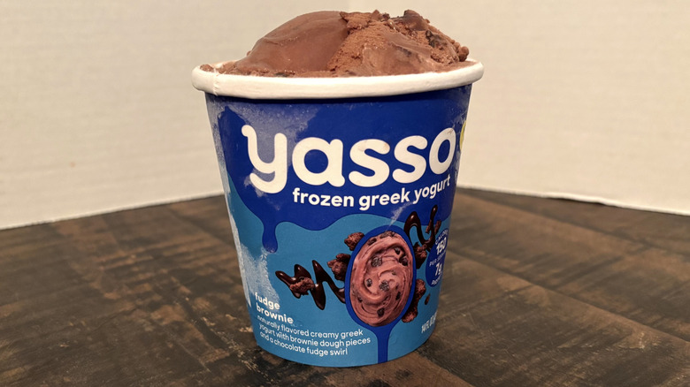 Yasso fudge brownie frozen yogurt in pint on wooden table