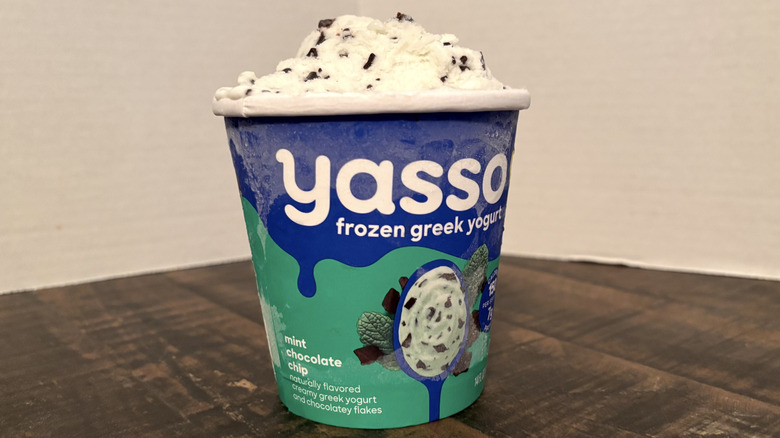 Yasso mint chocolate chip frozen yogurt in pint on wooden table