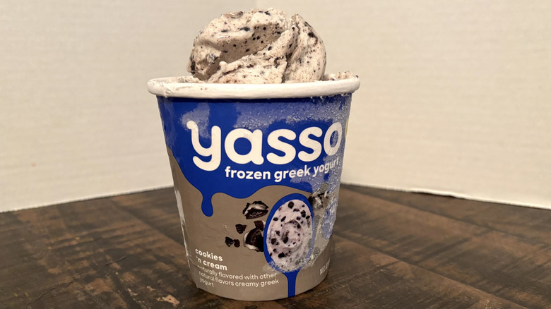 Yasso cookies n' cream frozen yogurt in pint on wooden table