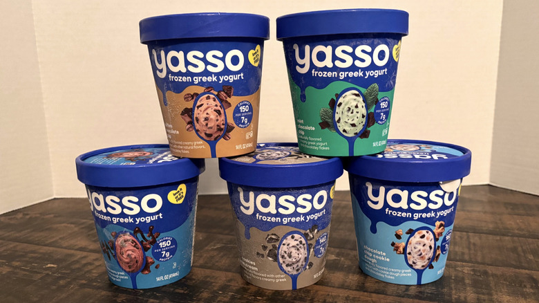 A variety of Yasso greek frozen yogurt pints on wooden table