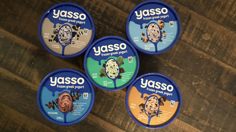A variety of Yasso greek frozen yogurt pints on wooden table