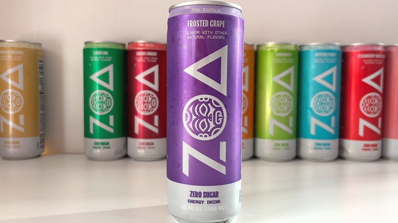 Can of Frosted Grape ZOA energy drink on white table, other cans behind