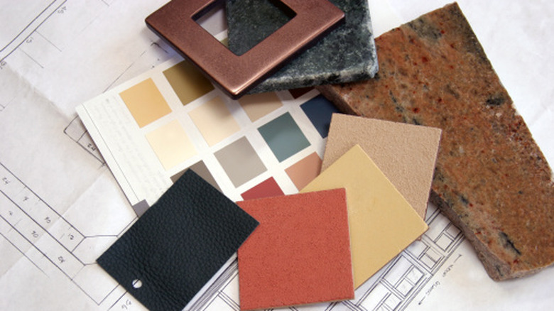 Samples for kitchen renovation are laid out, including granite, stone, and paint samples.
