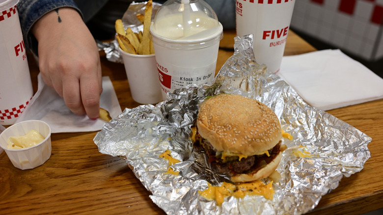 a burger with fries and a milkshake from Five Guys