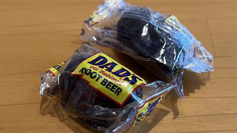 a close-up of two dad's root beet barrel candies on a table