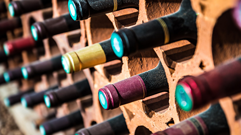 Close-up of a wine rack with bottle necks protruding