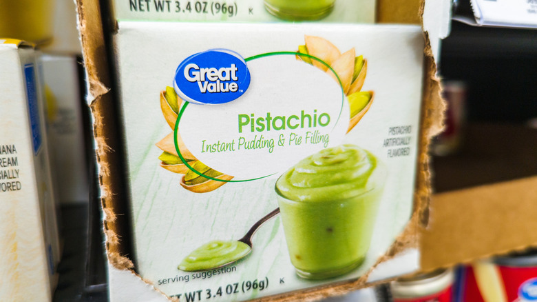 A box of Great Value pistachio instant pudding and pie filling on a store shelf