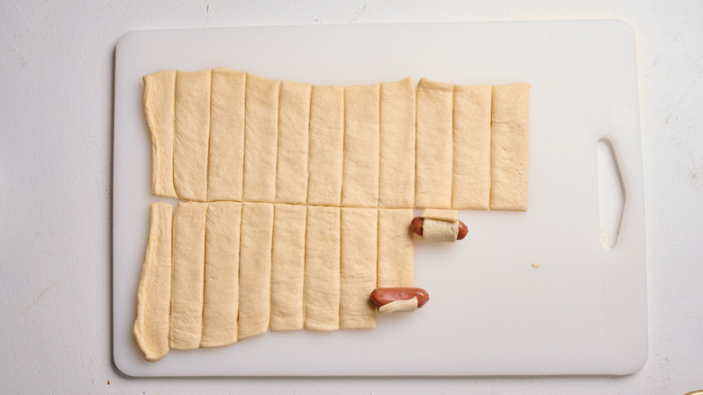 rolling sausages in dough