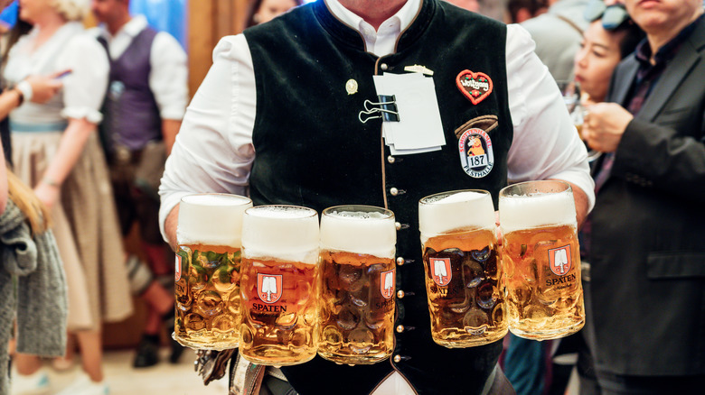 waiter carrying beer steins