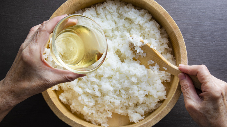 pouring vinegar into white rice