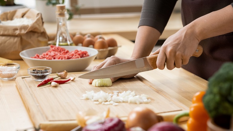 Chopping vegetables on cutting board