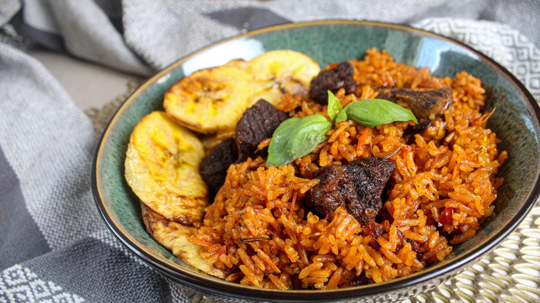 Rice jollof in a bowl with plantains