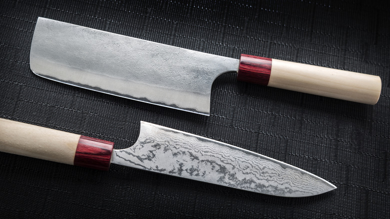 Wooden-handled Japanese chef's knives, one made from Damascus steel