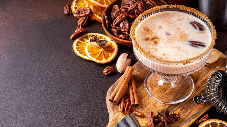 Pecan cocktail with dried fruits, cinnamon, pecans, on wooden board