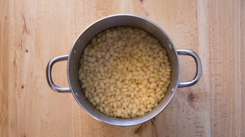 white beans soaking in pot