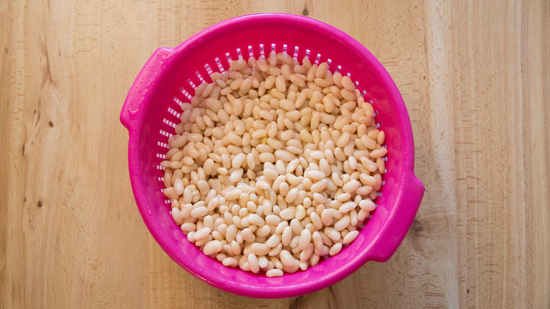 white beans in pink colander